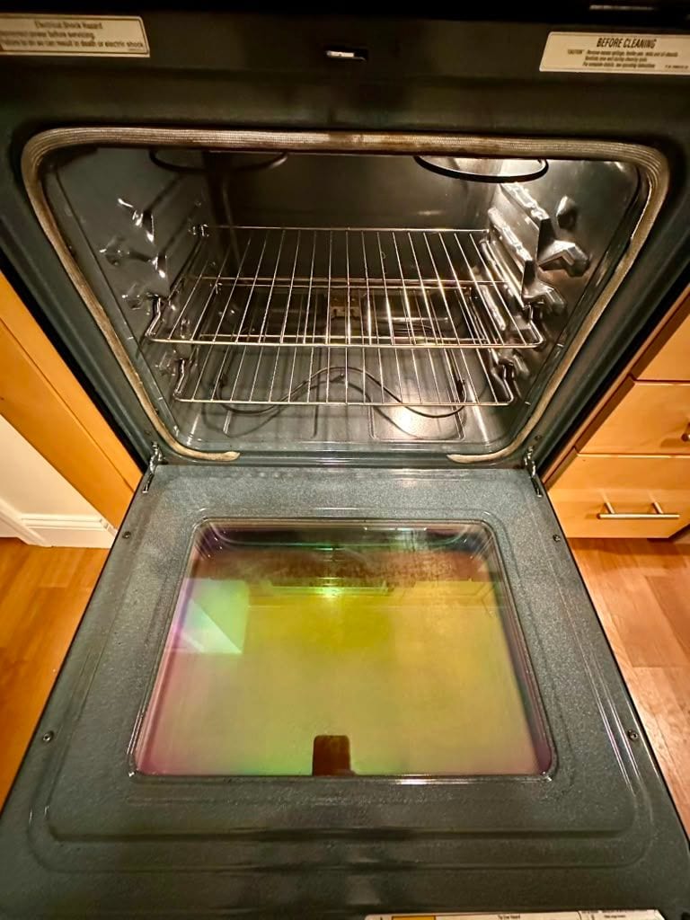 The same oven clean inside, with clear racks and door glass
