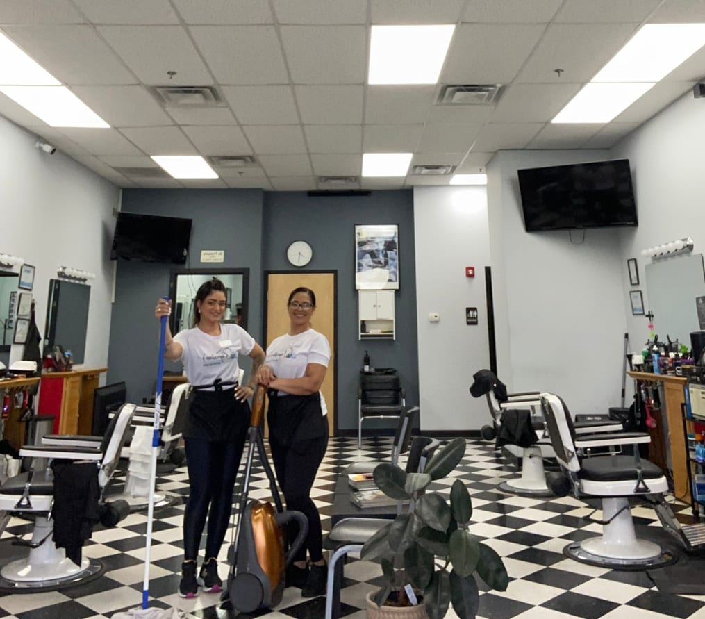 Two Cupertino's team members inside a barbershop the company cleans on a recurring schedule