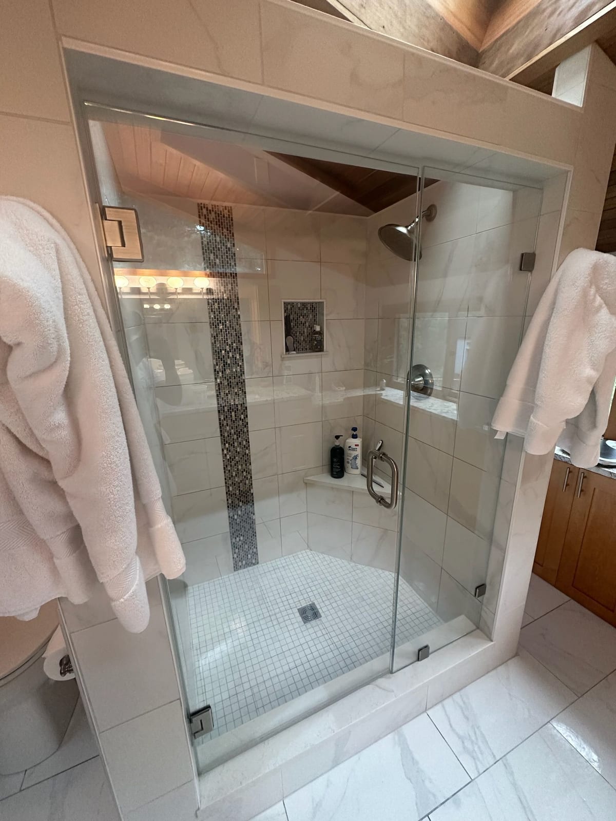 A glass shower enclosure left clear and streak free