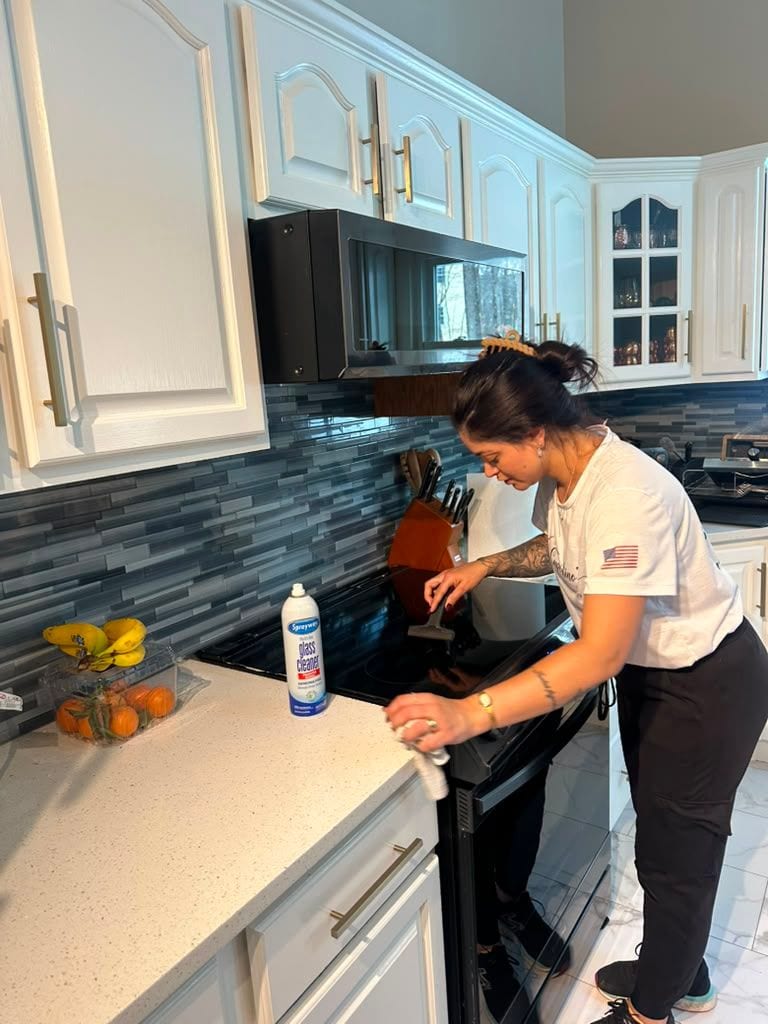 A Cupertino's team member cleaning a kitchen counter