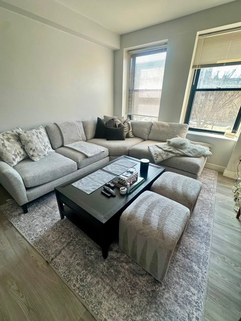 A bright living room with sectional sofa and coffee table after a residential cleaning